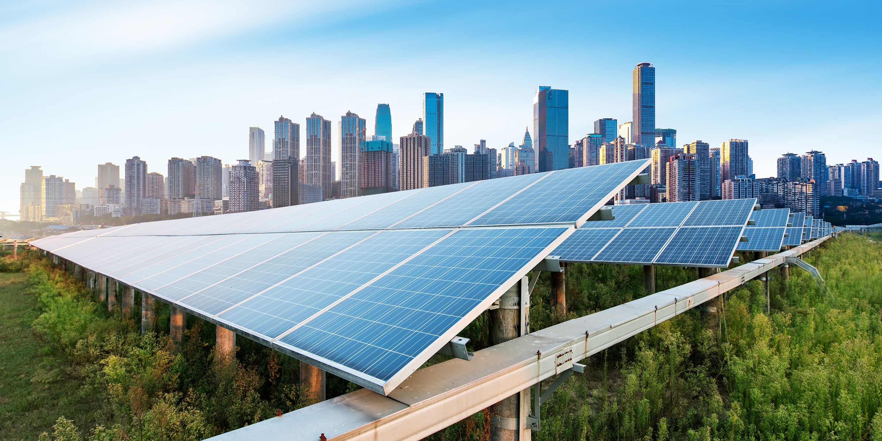 Employees in meeting, sitting at conference room table.